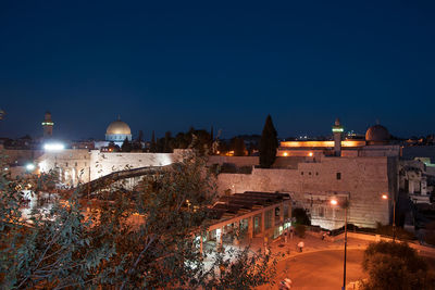 High angle view of illuminated buildings in city at night