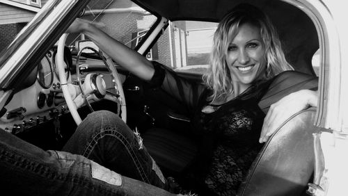 Portrait of smiling woman sitting in car