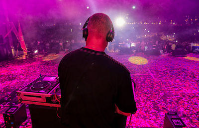 Rear view of man standing at music concert