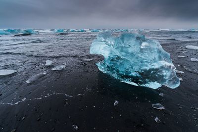 Aerial view of frozen sea against sky