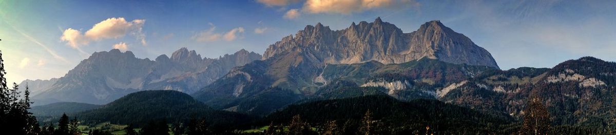 Panoramic view of mountains against cloudy sky