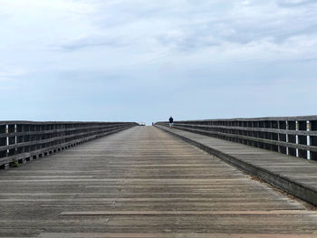 Surface level of footbridge against sky