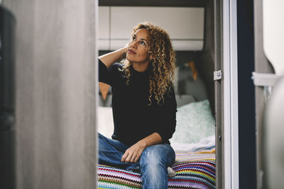 Portrait of young woman sitting at home