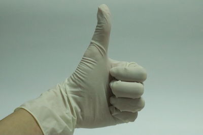 Close-up of man hand against white background