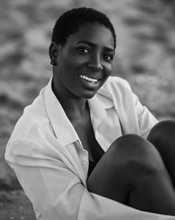 Portrait of smiling woman sitting outdoors