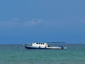 Boat sailing in sea against sky