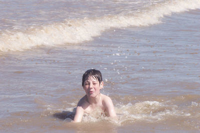 Boy enjoying in sea at beach