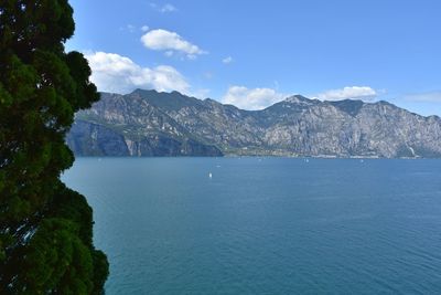 Scenic view of sea and mountains against sky