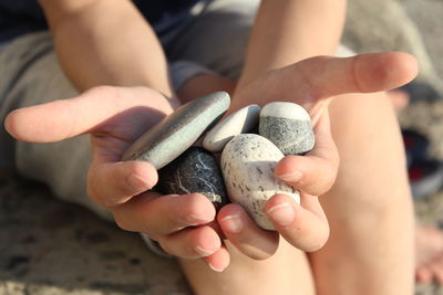 Close-up of hand holding stones