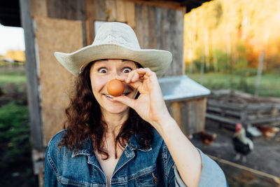 Young woman wearing hat standing outdoors