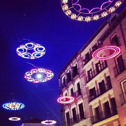 Low angle view of illuminated lights at night