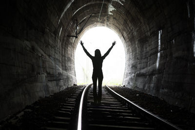 Rear view of silhouette man in tunnel