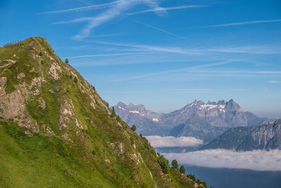 Scenic view of mountains against blue sky