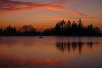 Scenic view of lake against orange sky