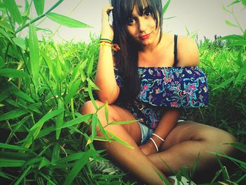 Portrait of young woman on field