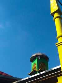 Low angle view of building against clear blue sky