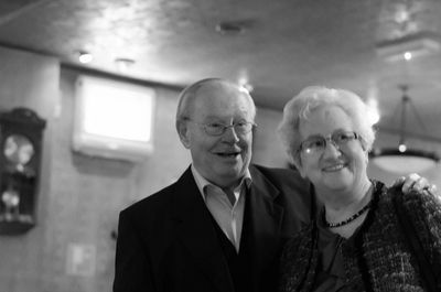 Smiling senior couple at illuminated room