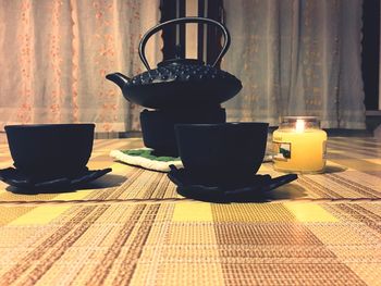 Close-up of tea light candles on table at home