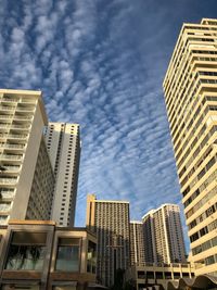 Low angle view of modern buildings in city against sky