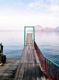 Empty pier on sea against sky