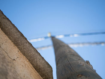 Close-up of metallic structure on beach against clear sky