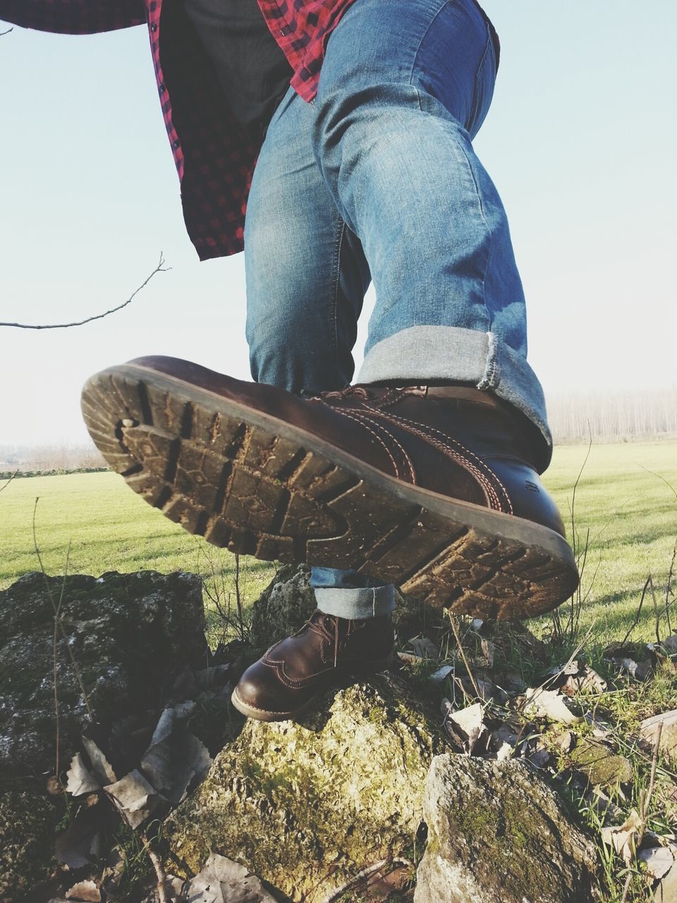 lifestyles, low section, leisure activity, men, person, grass, shoe, field, casual clothing, standing, unrecognizable person, sitting, day, holding, outdoors, rear view, jeans