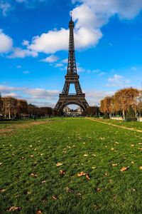 View of tower on field against cloudy sky