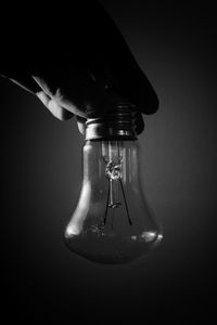 Close-up of light bulb against black background