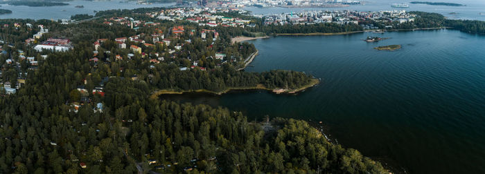 High angle view of trees and buildings by sea