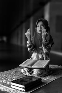 Portrait of woman sitting on table