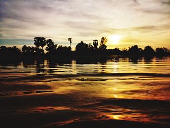 Scenic view of lake against orange sky