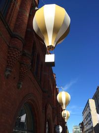 Low angle view of illuminated street light against sky