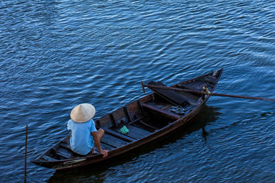 Man sitting on boat in lake