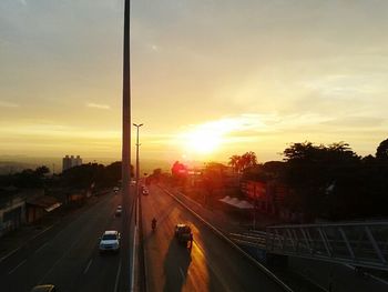 Cars on road at sunset