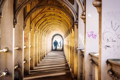 Man walking in corridor of building