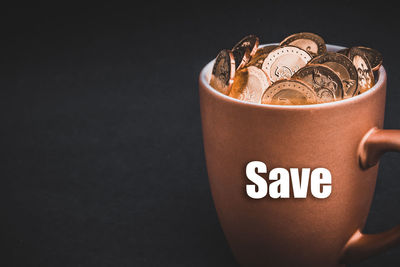 Close-up of coffee cup against black background