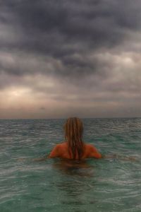 Scenic view of sea against cloudy sky