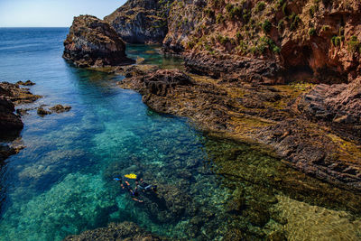 Father and son have diving in the sea. active lifestyle. equipment, mask and fins. snorkeling