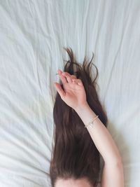 High angle view of woman lying on bed