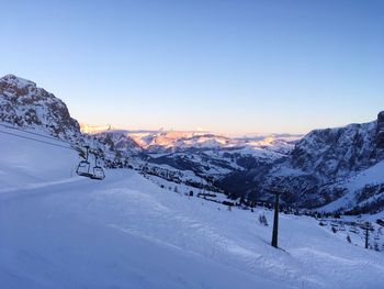 Snow covered mountains against clear blue sky