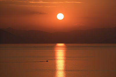 Scenic view of sea against romantic sky at sunset