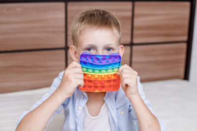 Portrait of cute boy holding camera