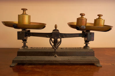 Close-up of vintage weighing scale on table