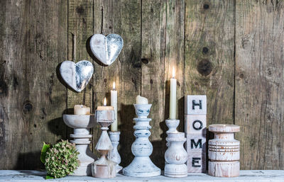 Illuminated candles on candlestick holder at table