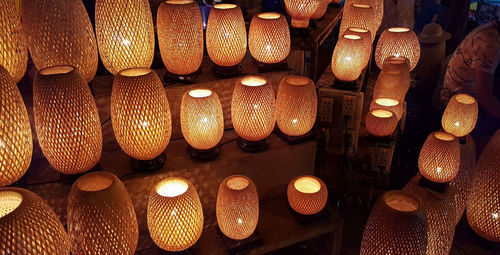 Illuminated lanterns hanging in store for sale