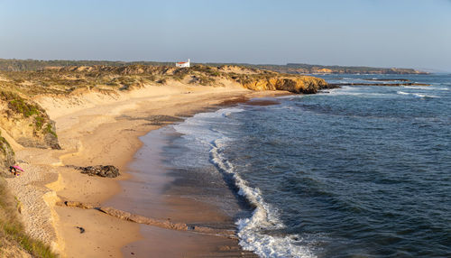 Scenic view of beach against clear sky