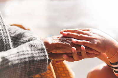 Grandmother holding grandchildren's hand with concern