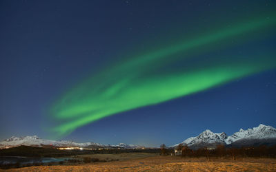 Scenic view of snowcapped mountains against sky at night