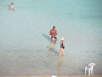 High angle view of people enjoying in sea