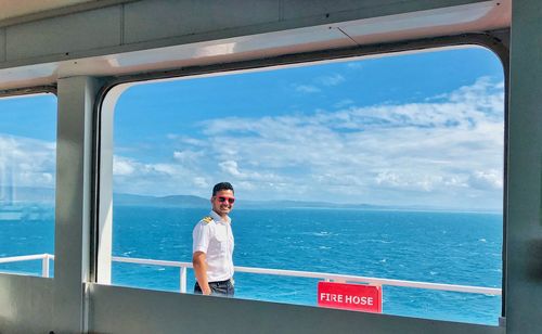 Man standing by sea against sky